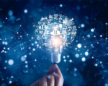Hand holding light bulb and business digital marketing innovation technology icons on network connection, blue background