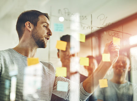 Cropped shot of a group of young designers using sticky notes during a brainstorming session